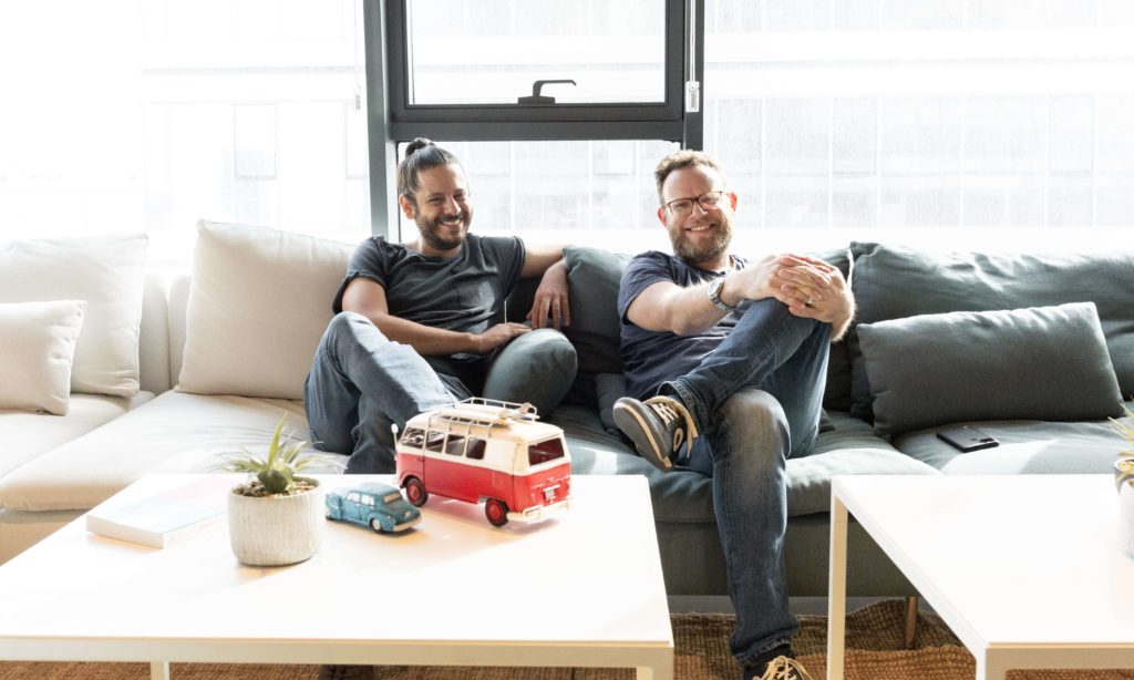 Frame.io-28-min Two men sitting next to each other on the couch